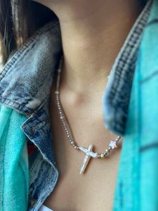 A stunning blend of 3mm faceted silver hematite paired with natural pink and star shaped pearl, featuring a delicate pearl cross.

&nbsp;This unique piece is perfect for layering or making a statement on its own.

Silver 18k plated clasp